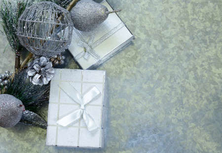 Christmas background fir branches with silver decorations and gift boxの写真素材