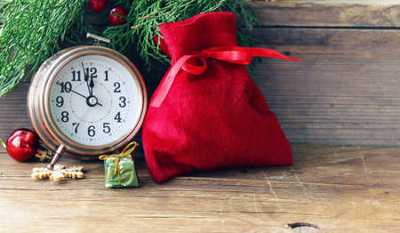 Christmas composition with fir branches, decorations and old clockの写真素材
