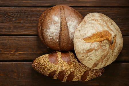 homemade fresh bread rye, sesame, white on a wooden background