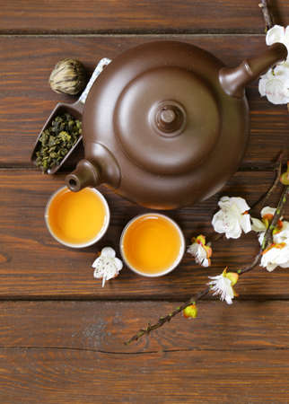 tea set teapot, cups and different green tea a wooden background, top viewの写真素材