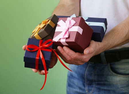 gift boxes with festive ribbons in male handsの写真素材
