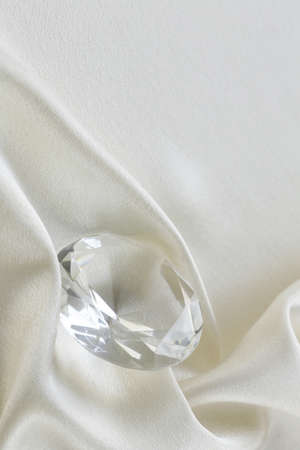 large glass diamond on soft silk backgroundの写真素材