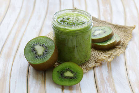 homemade fruit jam kiwi on the wooden tableの写真素材