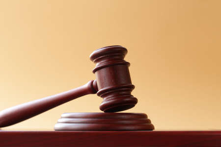 gavel on a stand on a wooden background