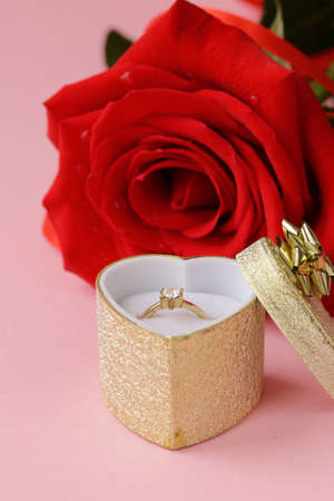 red rose flower with a gold ring with a diamondの写真素材