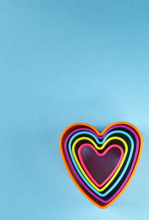 colorful plastic hearts on a blue backgroundの写真素材