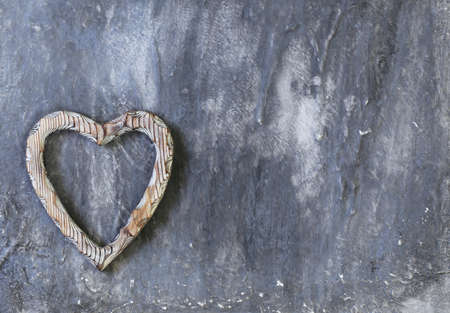 Wooden heart symbol on a gray backgroundの写真素材