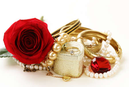 gold jewelry pearls, necklace, ring with roses on a white backgroundの写真素材