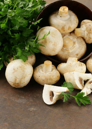 natural organic raw mushrooms champignons on tableの写真素材