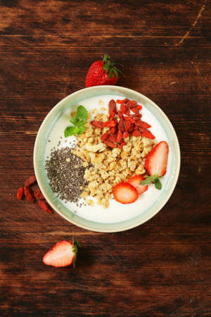 healthy breakfast of muesli, yoghurt, chia seeds, fruit and gojiの写真素材