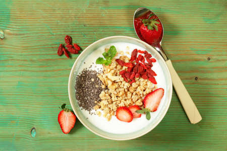 healthy breakfast of muesli, yoghurt, chia seeds, fruit and gojiの写真素材