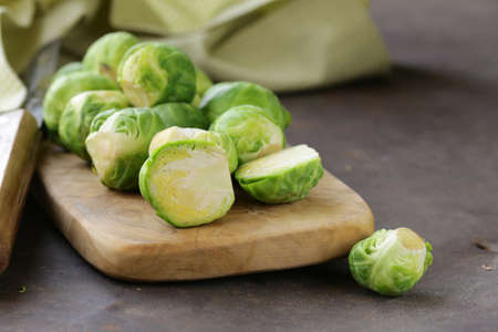 raw fresh organic brussels sprouts on cutting board