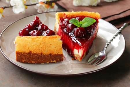piece of cherry cheesecake and leaves of fresh mintの写真素材