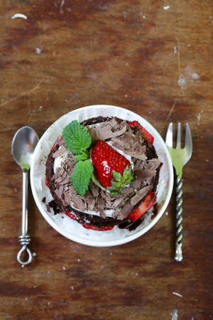 chocolate dessert cake with strawberries and whipped cream