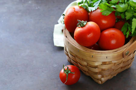 Juicy ripe organic tomatoes in a basketの写真素材