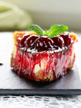 piece of cherry cheesecake and leaves of fresh mintの写真素材