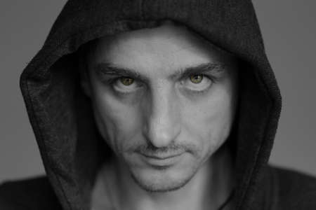 portrait of blonde man with blue eyes in the hood