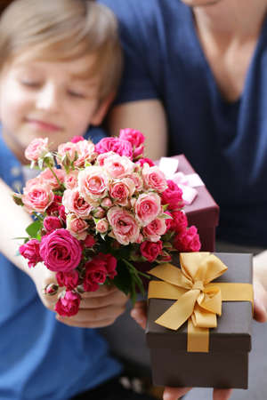husband and son presented to  mom flowers and giftsの写真素材