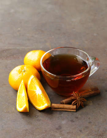 glass cup with tea and citrus fruits on the tableの写真素材