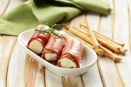 Italian appetizer soft cheese wrapped in parma hamの写真素材