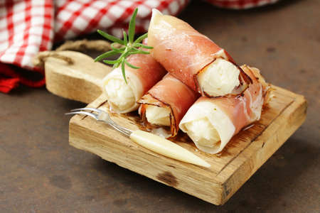 Italian appetizer soft cheese wrapped in parma hamの写真素材
