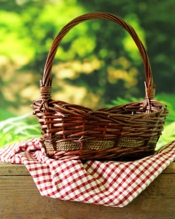 empty wicker basket and checkered plaid for picnicの写真素材