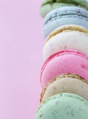 French multicolored almond cookies macaroons on a pink backgroundの写真素材