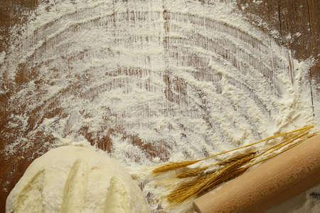 flour and wheat ears on the wooden table