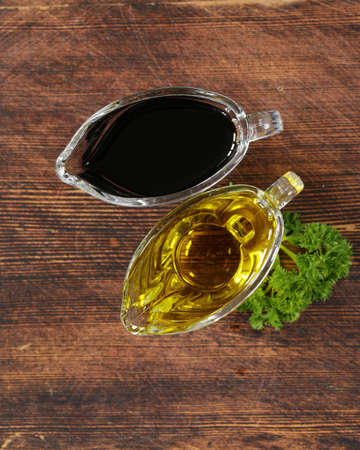 olive oil and balsamic vinegar in a glass gravy boatの写真素材