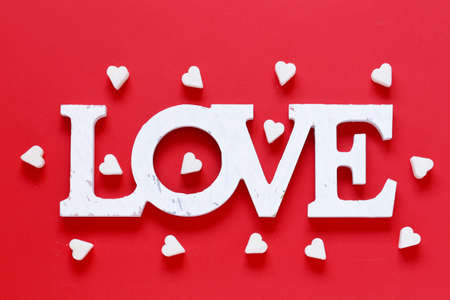 Festive red background and sweet sugar hearts, valentines dayの写真素材