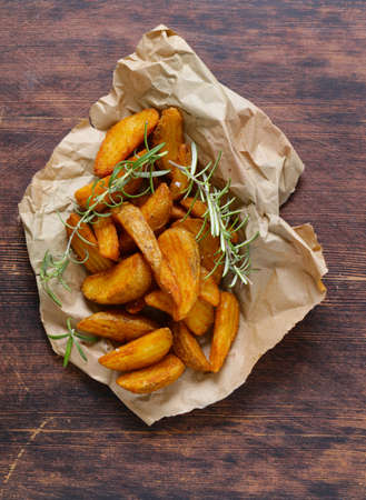 slices of fried potatoes with rosemary and spicesの写真素材