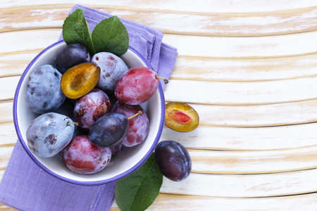 fresh organic purple plums on a wooden tableの写真素材