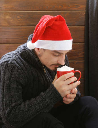 man holding a mug hot cocoa with marshmallows, winter Christmas drinkの写真素材