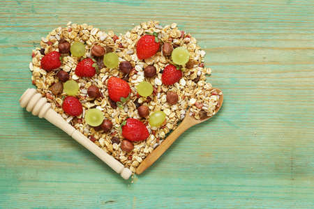 healthy eating granola cereal with nuts and fruit, in the shape of a heartの写真素材