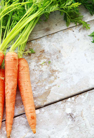 ripe organic carrots on a wooden tableの写真素材