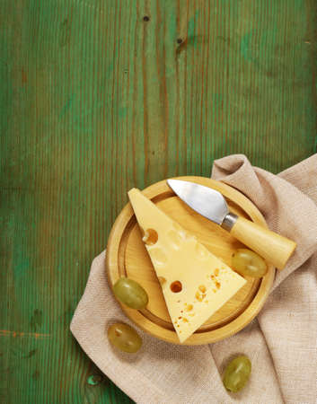 natural cheese Maasdam on a wooden tableの写真素材