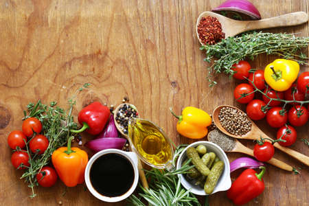herbs and spices, vegetables and sauces on wooden background
