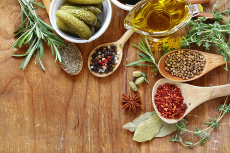 herbs, spices and sauces on wooden backgroundの写真素材