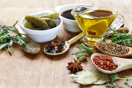 herbs, spices and sauces on wooden background