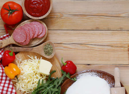 dough, tomato sauce, cheese, sausage - the ingredients for pizzaの写真素材