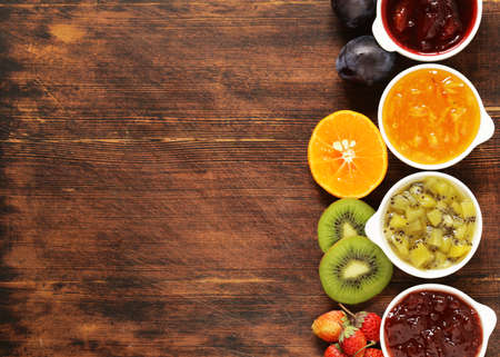 Assorted berries and fruit jams. Homemade canning. Fresh berries and fruitsの写真素材