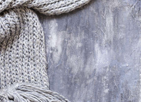 Gray background with beautiful knitted scarfの写真素材