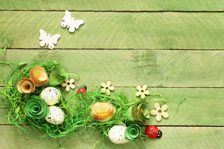 wooden background with Easter symbols, eggs, butterflies, flowersの写真素材