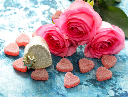 Pink flowers of roses and candy hearts for Valentines holidayの写真素材