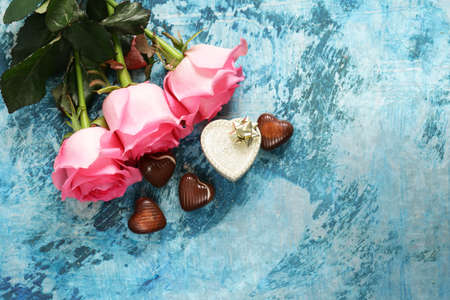 Pink flowers of roses and candy hearts for Valentines holidayの写真素材