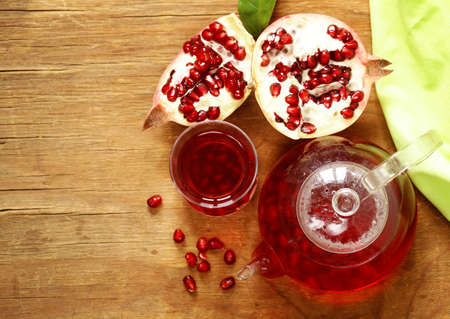 Fruit pomegranate tea in a teapot and cupの写真素材