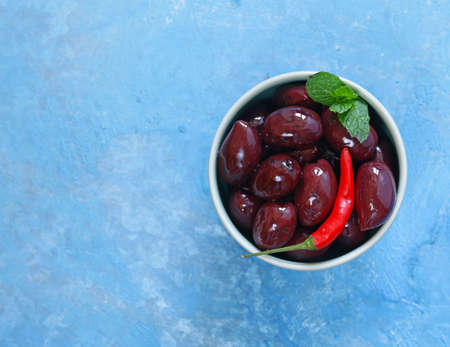 red kalamata olives on a wooden tableの写真素材