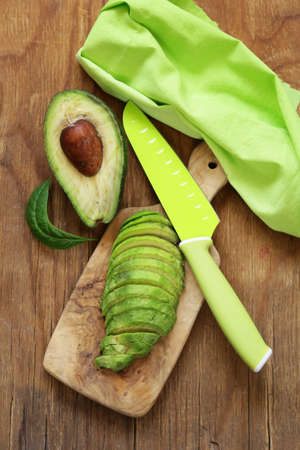 healthy eating - ripe avocado on a wooden boardの写真素材