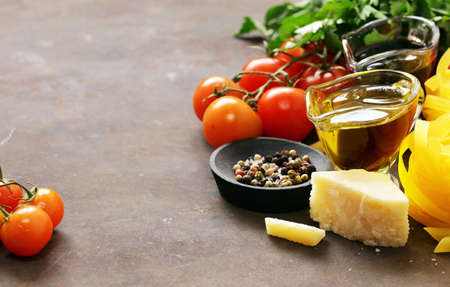 Italian food ingredients - vegetables, olive oil, spices and pasta