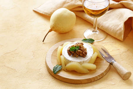 Organic camembert cheese with nuts and pearsの写真素材
